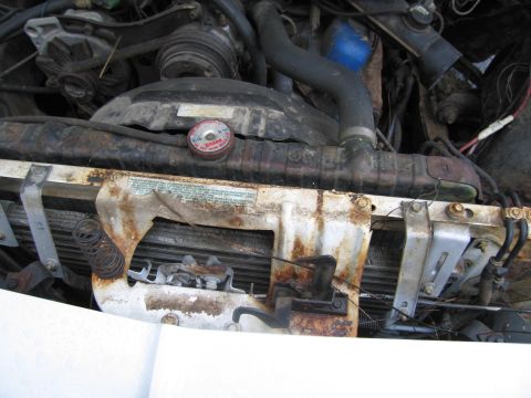 1991 Ford LTD Crown Victoria - Close-up of a car's engine bay, focusing on the radiator and fan shroud components.