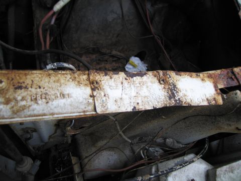 1991 Ford LTD Crown Victoria - Close-up of a rusty metal beam in an engine bay, with partial text visible.