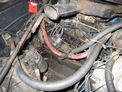 1991 Ford LTD Crown Victoria - Close-up view of a cluttered engine bay with various hoses and electrical wiring.
