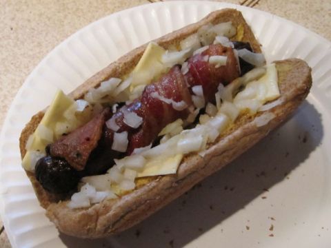 1990 Ford Bronco - A close-up view of a loaded hot dog on a paper plate, showing its various toppings.
