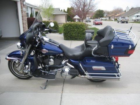 2007 Harley-Davidson Electra Glide Clsc - A blue 2007 Harley-Davidson Electra Glide Clsc motorcycle is parked in a suburban driveway. The motorcycle features a large windshield and…
