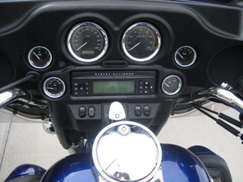 2007 Harley-Davidson Electra Glide Clsc - The dashboard of a motorcycle features multiple gauges and a radio with the Harley-Davidson logo.
