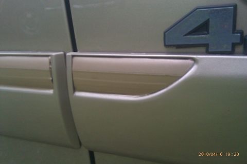 2000 Mercury Grand Marquis - Vehicle door detail with trim and a '4' badge visible.