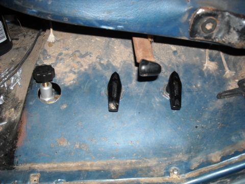 1979 Ford F-150 - Close-up of the interior floor of a vehicle, showing pedals and knobs.