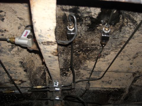 1979 Ford F-150 - Underbody view shows brake lines and a proportioning valve, likely from an older vehicle.