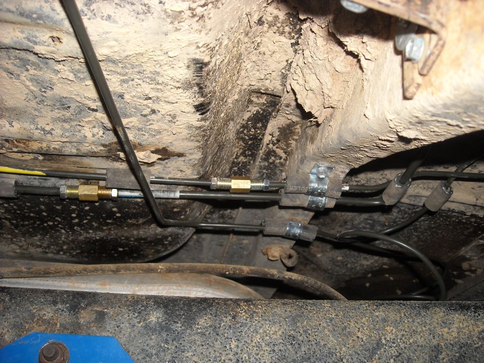 Underbody brake lines with brass fittings and metal clamps
