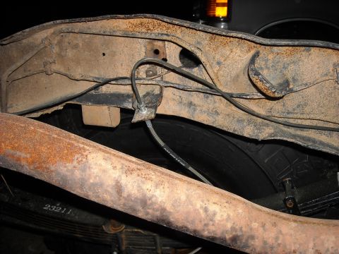 1979 Ford F-150 - Close-up of rusted truck frame and exhaust pipe with visible part number 23211.