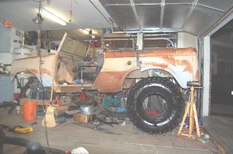 1961 International Scout 800 - A 1961 International Scout is in a garage, showing its body and frame during a restoration project.