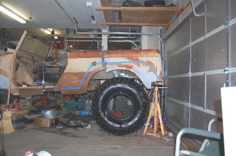 1961 International Scout 800 - Vehicle body undergoing modifications in a garage setting.