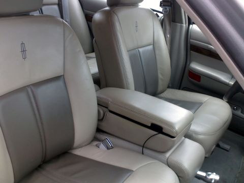1998 Mercury Grand Marquis - The interior features two-tone leather seats and a prominent center console, suggesting a luxury sedan.