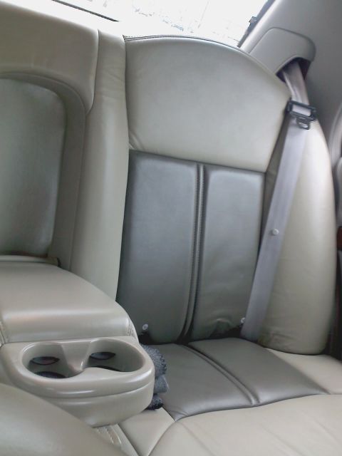 1998 Mercury Grand Marquis - Rear interior of a 1998 Mercury Grand Marquis, showing seats and armrest with cup holders.
