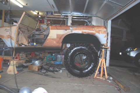 1961 International Scout 800 - A partially disassembled 1961 International Scout 800 sits in a garage, undergoing restoration work.