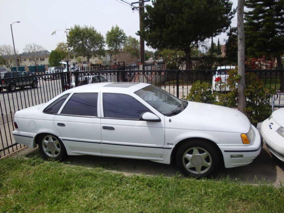 White 1995 Ford Taurus sedan, side view