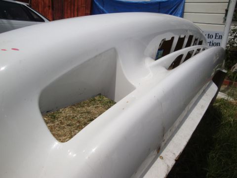 1995 Ford Taurus - A white fiberglass body panel with large cutouts sits outdoors on a sunny day.