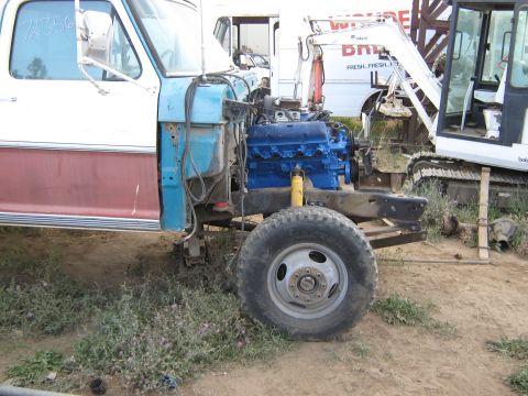1972 Ford F-250 - The front clip of a 1973 Ford F-250 truck is removed, revealing a blue engine and chassis components.
