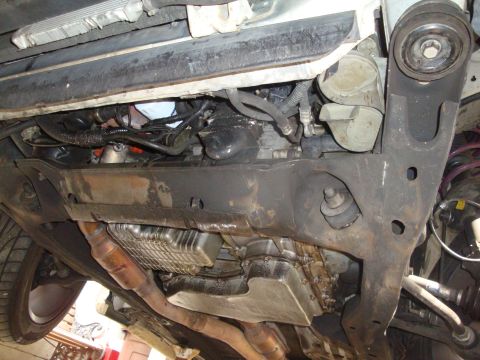 1995 Ford Taurus - A view of the undercarriage of a vehicle, revealing its mechanical components and exhaust system.