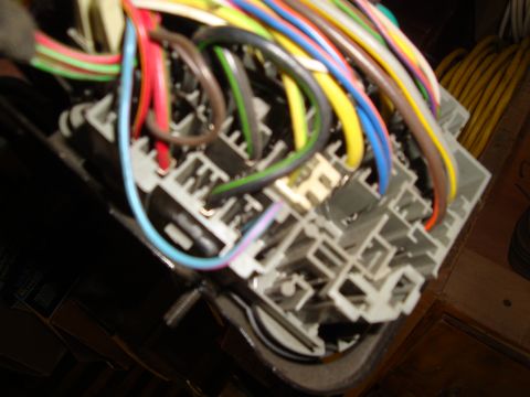 1995 Ford Taurus - Close-up view of a vehicle's fuse box with numerous colorful wires connected.