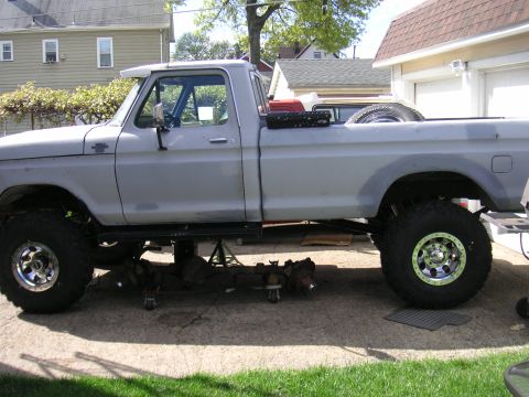 1979 Ford F-250 - This lifted 1979 Ford F-250 is undergoing front-end maintenance, with the axle and suspension components removed.