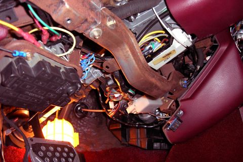 1992 Ford Crown Victoria - A complex wiring harness and various electrical components are visible under the dashboard of a vehicle.