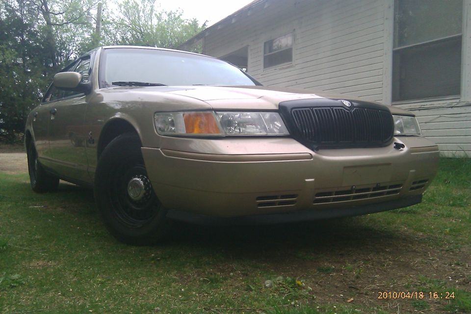Gold sedan with black grille, 3/4 front view