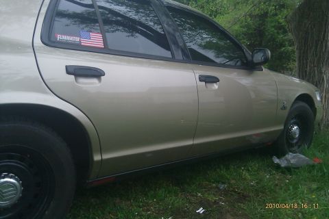 2000 Mercury Grand Marquis - Side profile of a 2000 Mercury Grand Marquis, a Flowmaster sticker on the rear window.