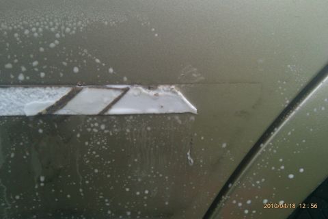2000 Mercury Grand Marquis - The door trim on this 2000 Mercury Grand Marquis is missing a section, revealing the underlying material.
