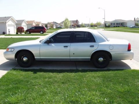 2000 Mercury Grand Marquis - This silver 2000 Mercury Grand Marquis is seen from the side in a suburban setting.