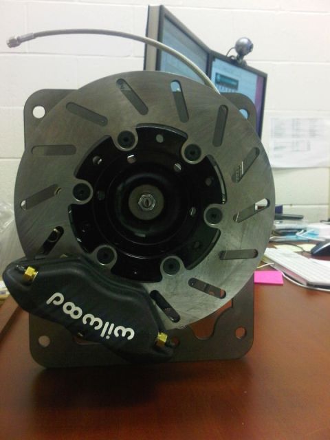 1996 Ford Bronco - A black Wilwood brake caliper is mounted to a rotor assembly, likely for a vehicle upgrade.