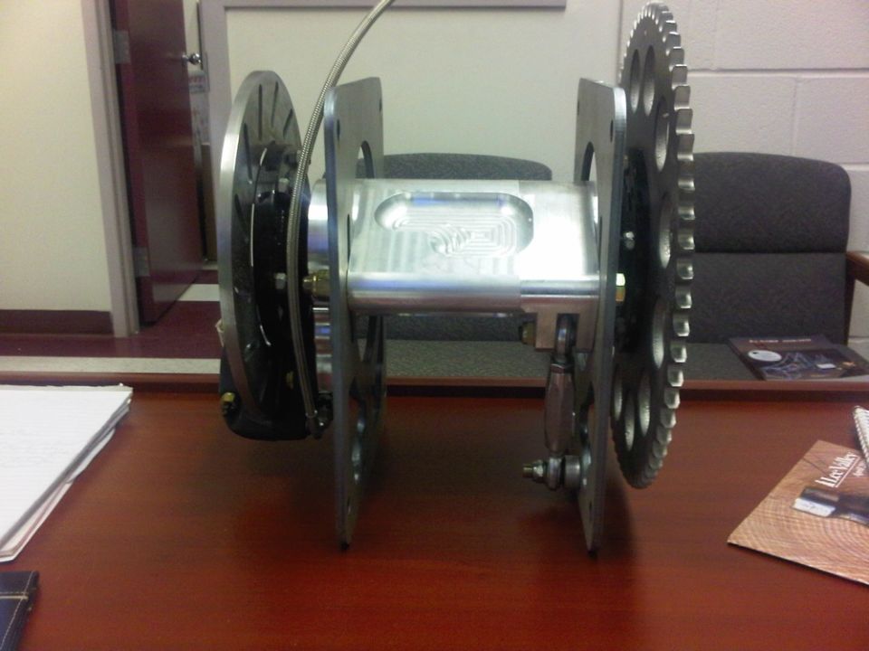 machined spool with sprocket and brake disc