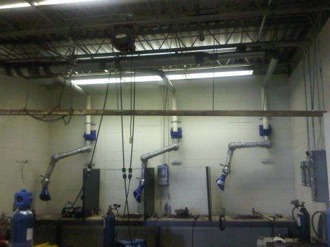 1996 Ford Bronco - Workshop scene with three industrial fume extraction arms mounted above a workbench.