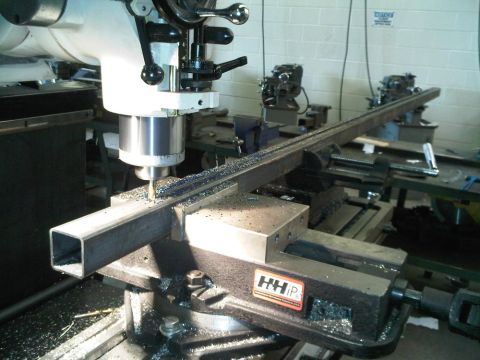 1996 Ford Bronco - Metalworking in progress: a milling machine precisely cuts a square metal bar.