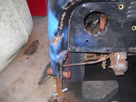 1954 Ford F-100 - Close-up of a rusted 1954 Ford F-100 fender and frame section, indicating repair needs.