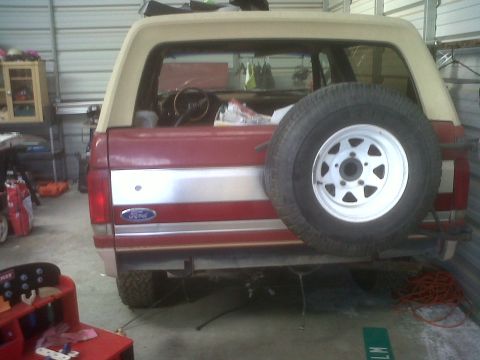 1989 Ford Bronco - Rear view of a 1989 Ford Bronco, showing the spare tire and taillights.