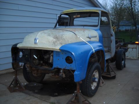 1954 Ford F-100 - This vintage Ford truck is in a state of disassembly, resting on jack stands in a driveway.