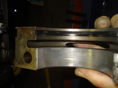 1979 Ford Bronco - Worn engine bearing showing scoring and a black insert, likely from an engine rebuild.