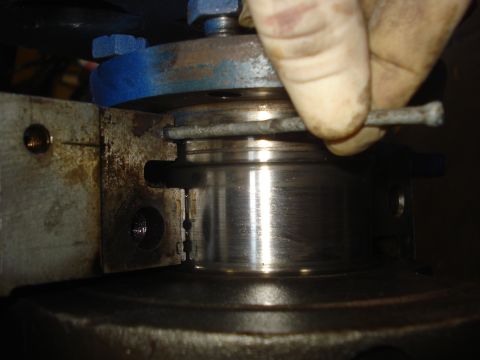 1979 Ford Bronco - A hand uses a tool to adjust a metal engine component, with visible "Supermotors.net" text at the bottom right.