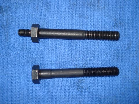 1979 Ford Bronco - Two threaded bolts are shown on a blue cloth background.