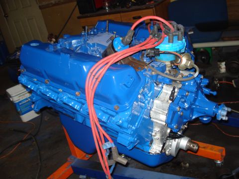 1979 Ford Bronco - A freshly painted V8 engine sits on an engine stand, ready for installation.