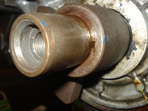 1979 Ford Bronco - A close-up view of a metal engine part, showing internal threading and external wear.
