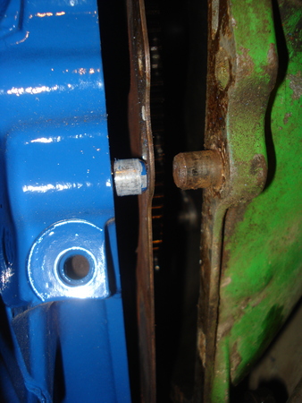 1979 Ford Bronco - Close-up view of two engine components, one blue and one green, connected by a bolt. Text from Supermotors.net is visible at the bottom.