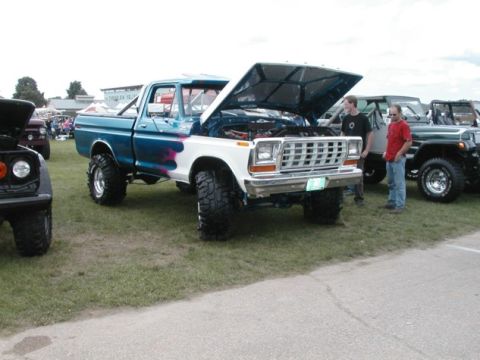 1994 Ford Bronco - This lifted Ford F-Series truck, likely from the late 1970s, is displayed with its hood open at an outdoor event.