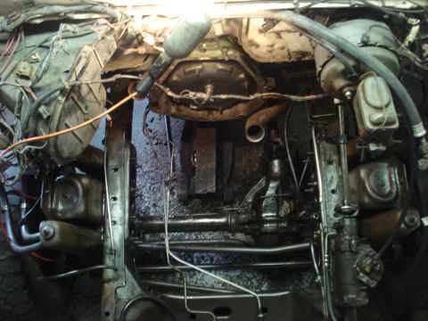 1979 Ford Bronco - Underside view of a vehicle's engine bay and chassis, revealing mechanical components and wiring.