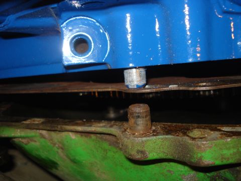 1979 Ford Bronco - Detail of engine parts, showing a bolt and mounting bracket. Text from Supermotors.net is visible.