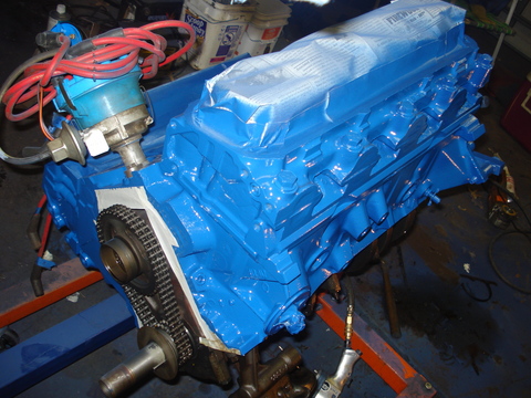 1979 Ford Bronco - A freshly painted blue engine block sits on a stand, ready for installation.