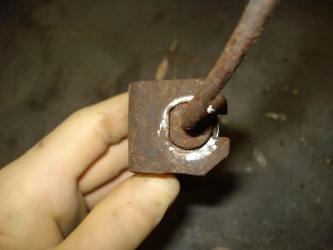 1979 Ford Bronco - Close-up of a corroded brake component, held by a person's hand.