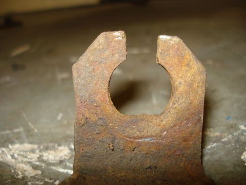 1979 Ford Bronco - Close-up view of a heavily rusted metal part, likely from a brake system, showing significant wear and corrosion.