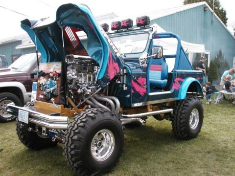 1994 Ford Bronco - Customized Jeep CJ with a highly modified engine and unique paint scheme on display.
