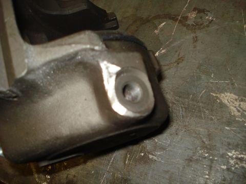 1979 Ford Bronco - Metal brake caliper bracket with a threaded hole, likely for a vehicle.