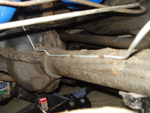 1979 Ford Bronco - Close-up of the rear axle assembly, showing brake lines and suspension components.