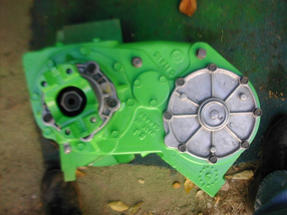 Lime green transfer case with cast Made in Canada lettering and aluminum cover